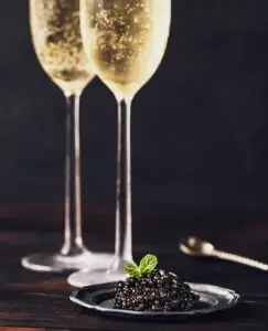 Glass of Champagne with caviar — luxury wine and gourmet experience in France
