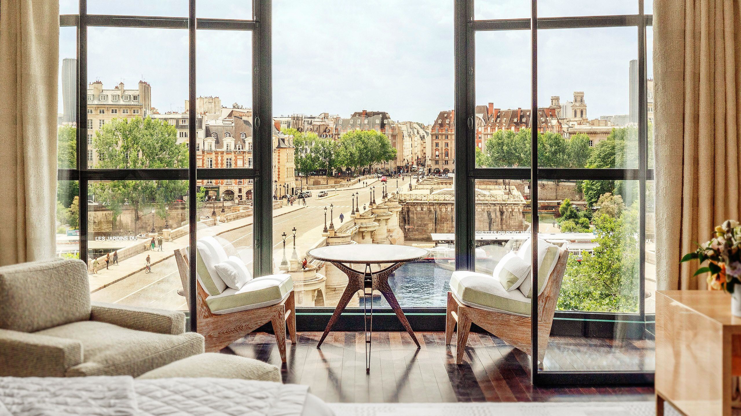 Cheval Blanc Paris hotel suite with floor-to-ceiling windows overlooking Pont Neuf and the Seine River, Paris, France