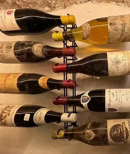 Curated collection of fine French wine bottles from Champagne, Burgundy and Bordeaux displayed together