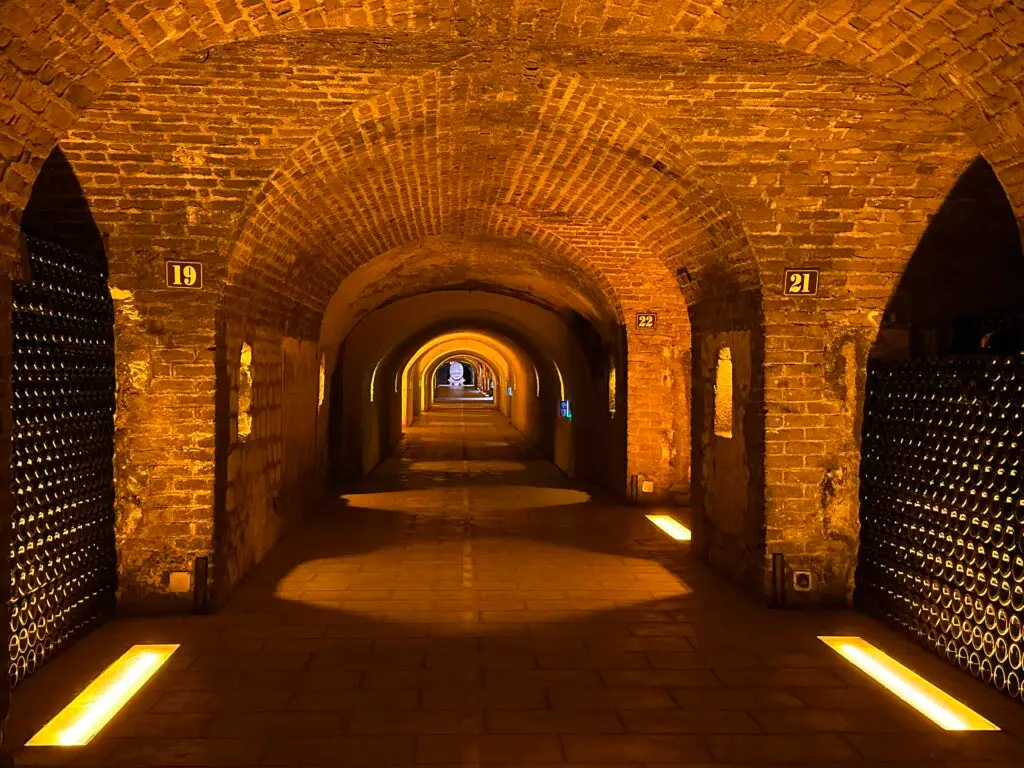 Underground champagne cellars with arched stone galleries in Reims, France.