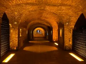 Underground champagne cellars with arched stone galleries in Reims, France.