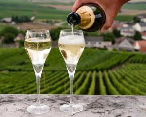 Pouring two glasses of Champagne in a vineyard in Hautvillers