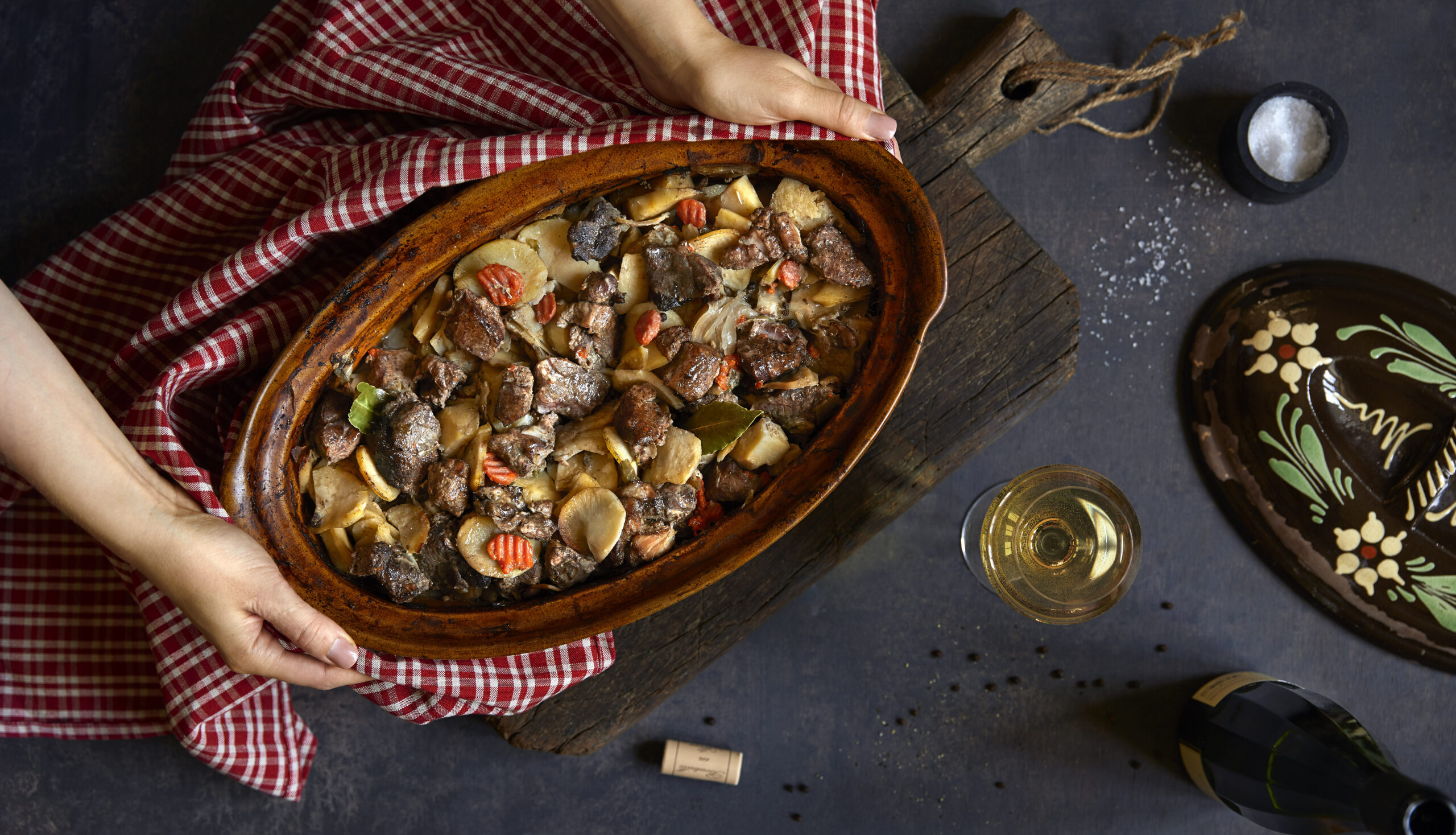 Traditional Alsatian Baeckeoffe meat and vegetable stew in terracotta dish with Riesling wine on a luxury Christmas wine tour in Alsace, France