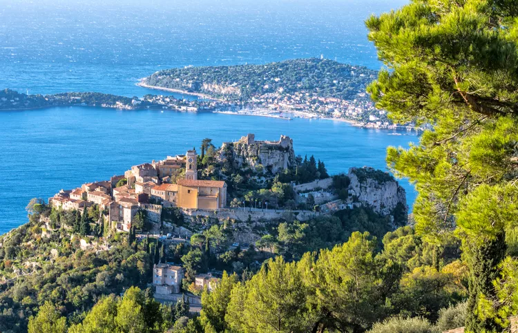 Aerial view of Èze perched village on rocky cliff above Mediterranean with Cap Ferrat peninsula on a luxury French Riviera tour, France