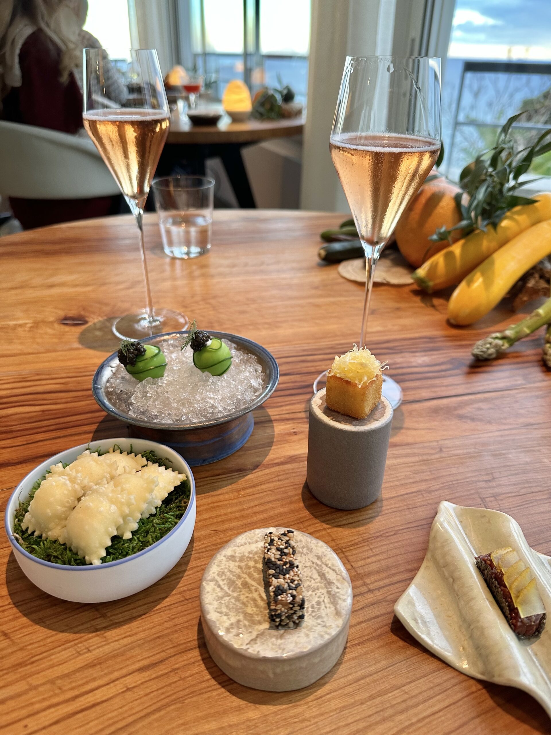 Rosé champagne and gourmet amuse-bouche at Mirazur 3 Michelin star restaurant in Menton on a luxury French Riviera tour, France