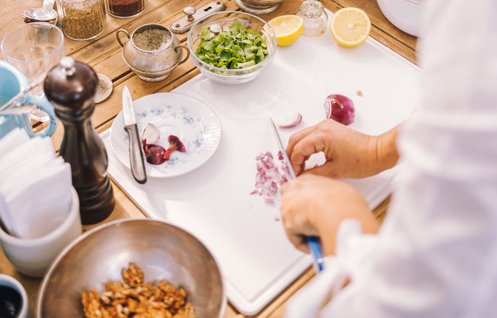 Chef chopping red onion at a French cooking class on a luxury Loire Valley wine tour, France